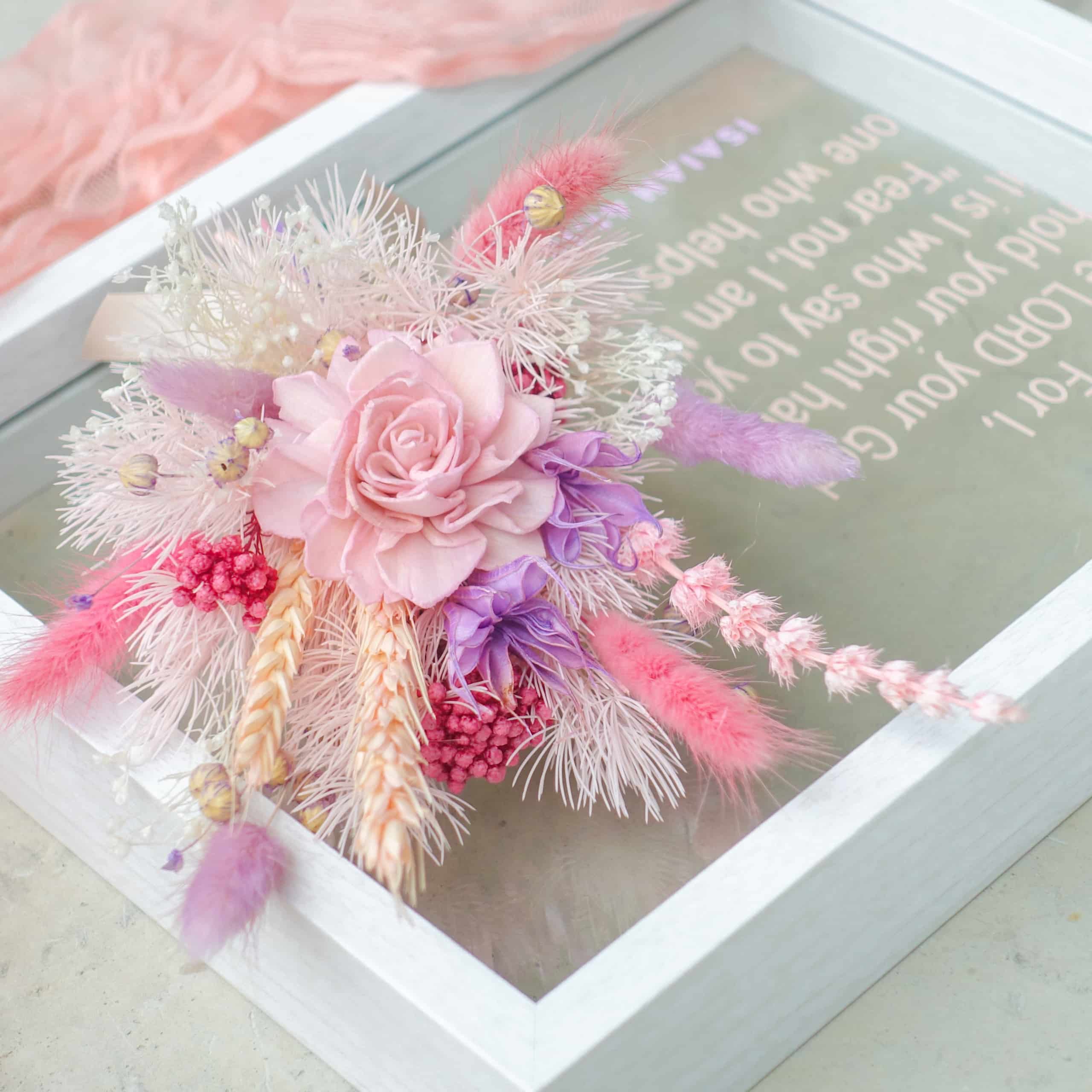 pastel pink light purple preserved flowers floral frame close up
