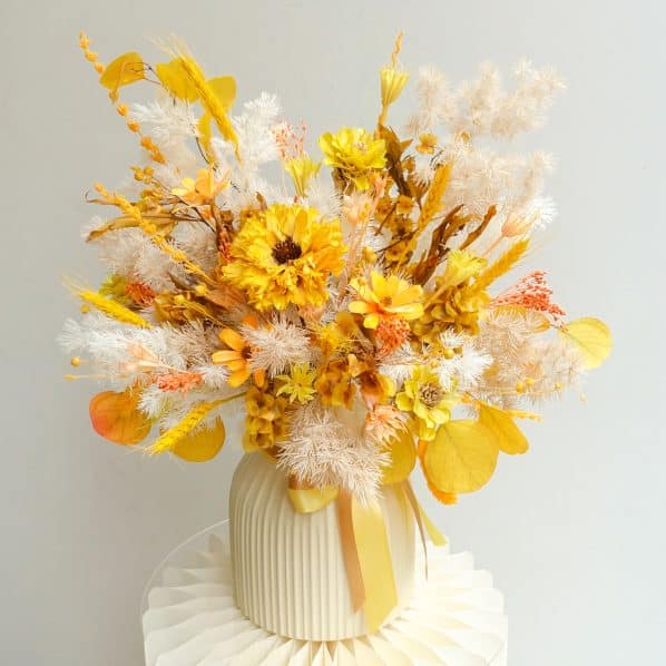 yellow orange beige vase arrangement