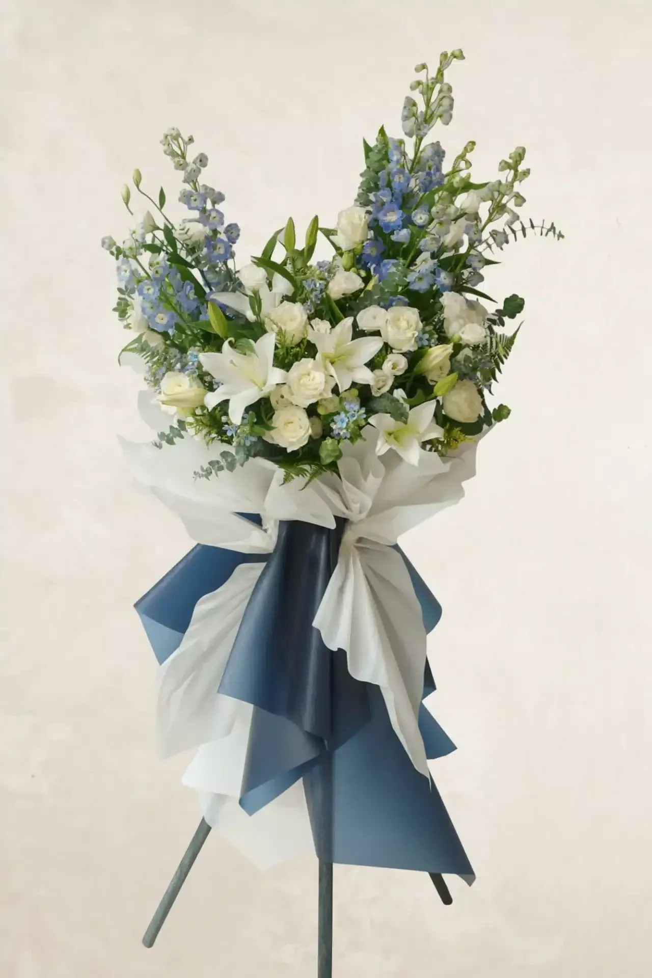 white-and-lilac-condolence-flowers-on-stand