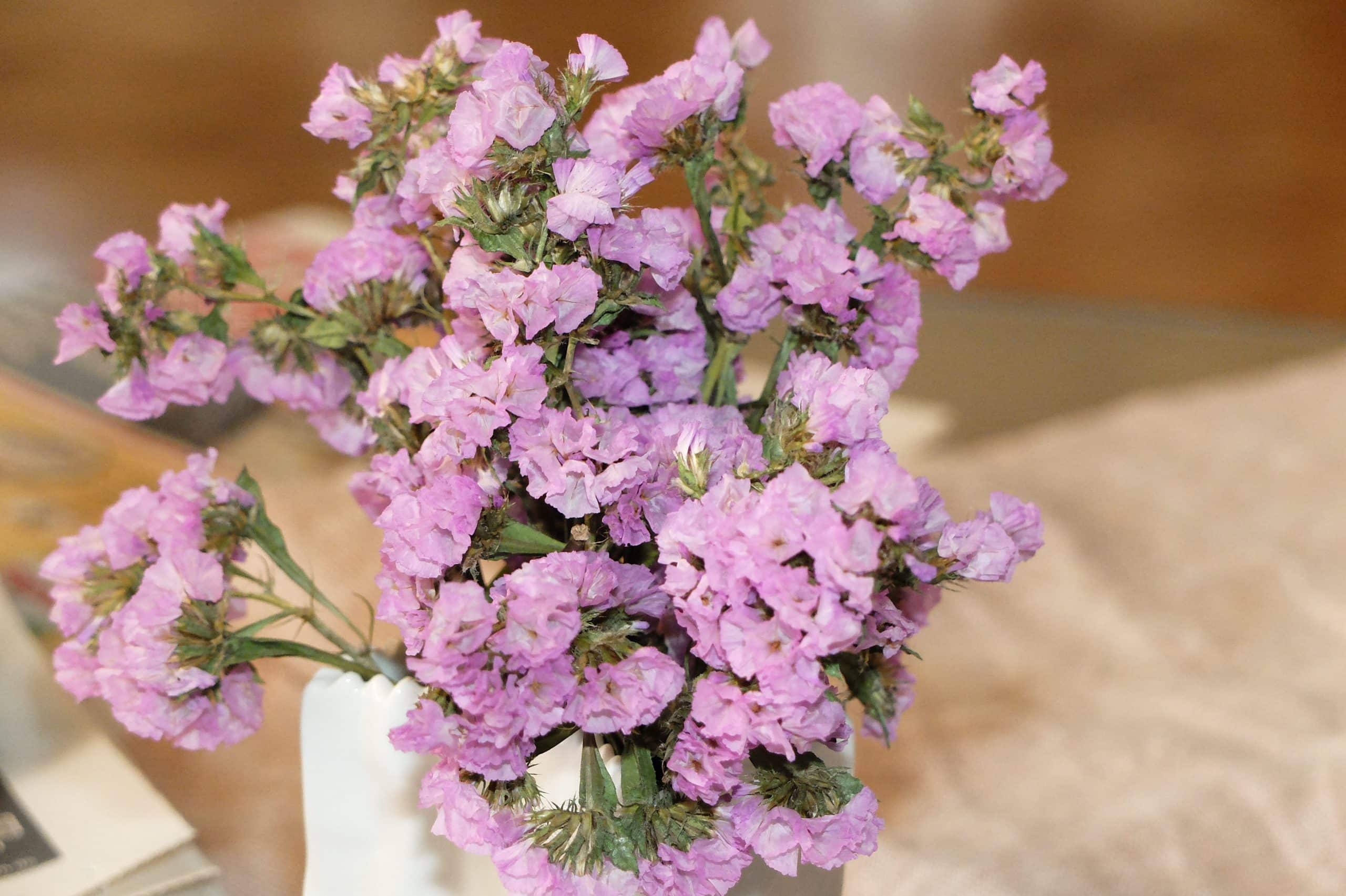 Purple Statice flowers in a graduation-themed floral arrangement.