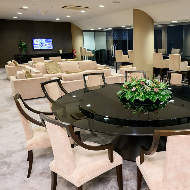 Beautiful floral arrangement on a black conference table in a contemporary meeting space.