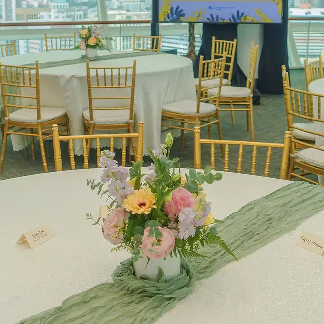 Elegant floral centerpiece with pink, yellow, and purple flowers at Donors Appreciation Night 2024.