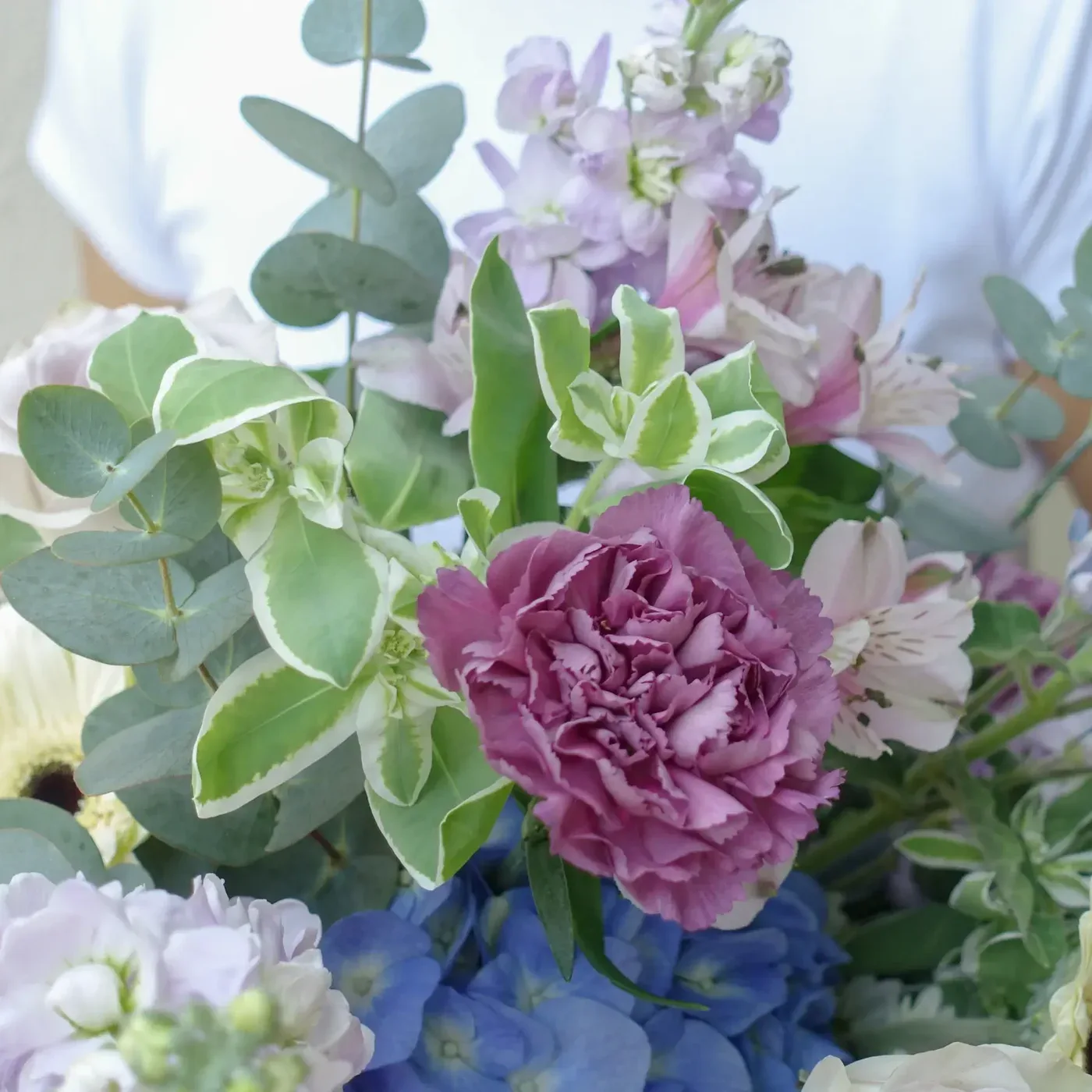 Elegant floral arrangement with pink, purple, and blue blooms for Rest in Grace theme.