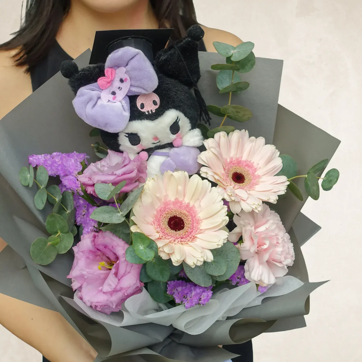 Beautiful floral bouquet with plush toy, pink gerbera daisies, and greenery.