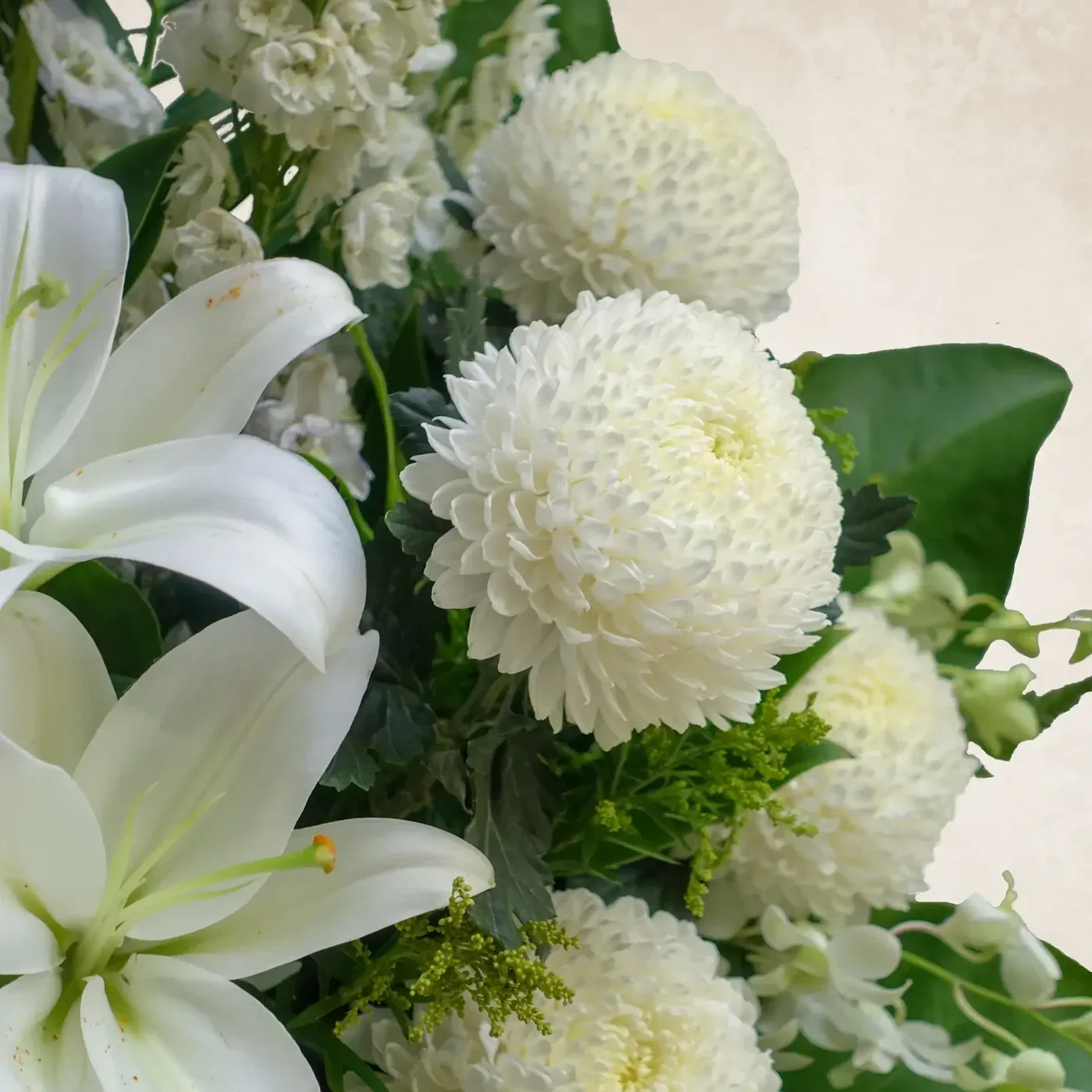 Beautiful white flowers including lilies and dahlias in a lush floral display. Perfect for serene an.