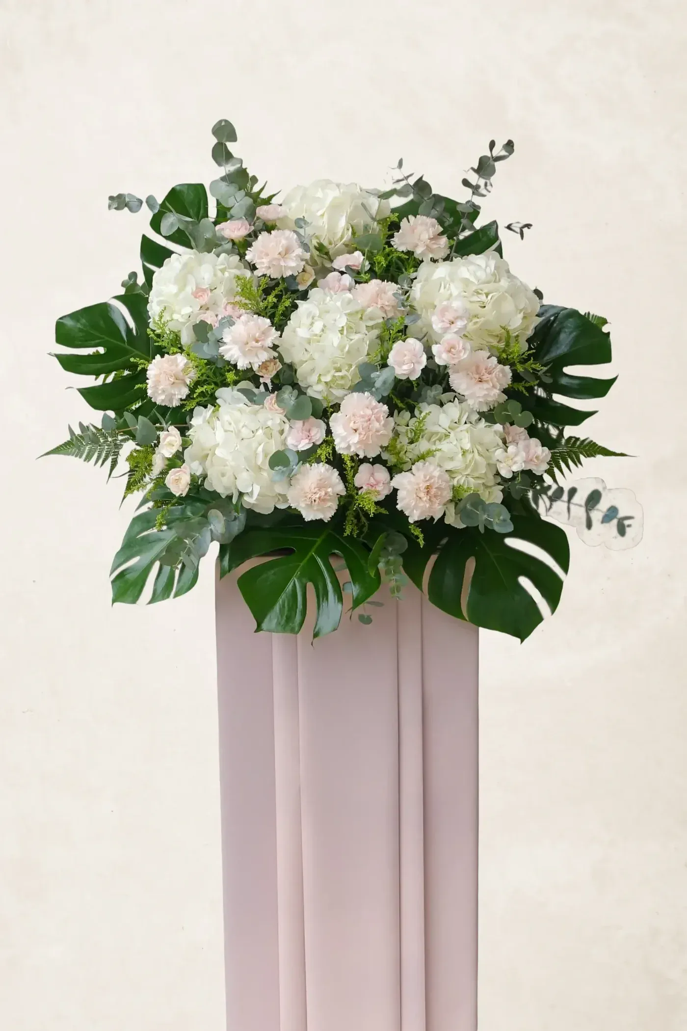 Beautiful white and blush flower bouquet with lush greenery, perfect for peaceful and graceful occas.