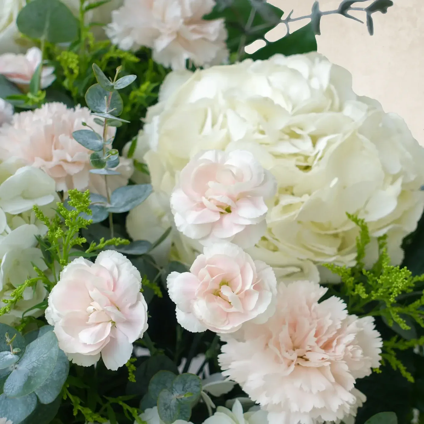 Elegant white and blush floral arrangement for serene and peaceful decor.