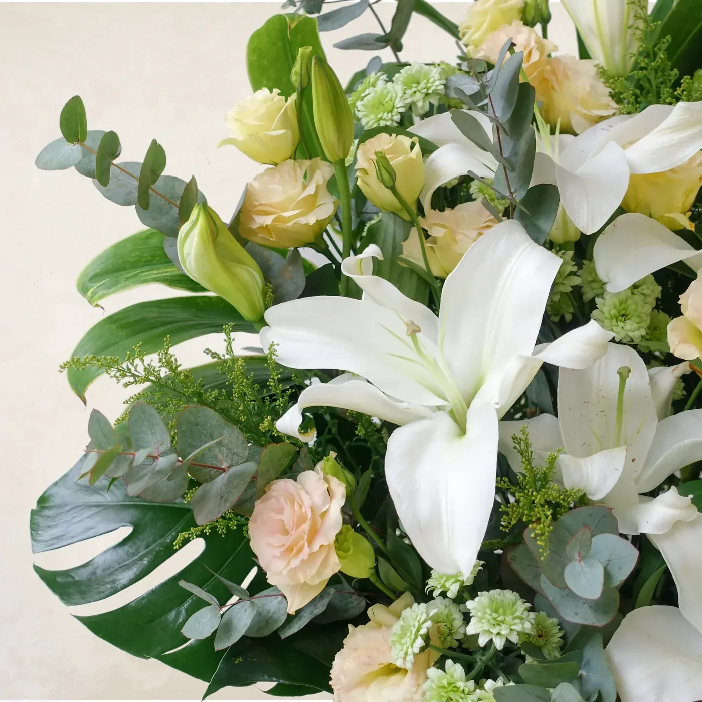 Beautiful white lilies and soft pastel roses in a graceful floral display.