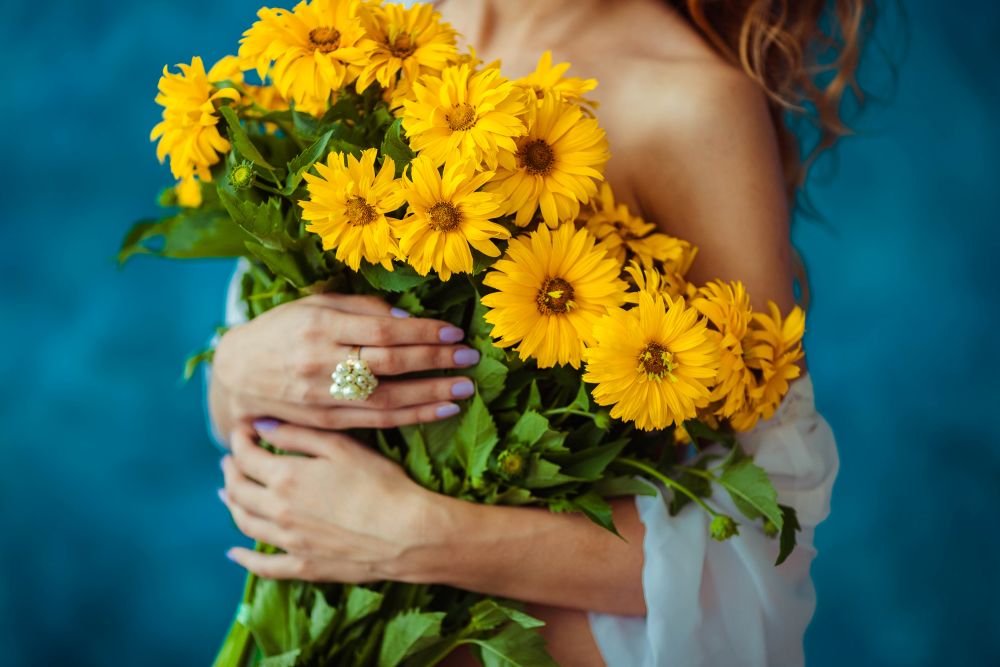 Bright yellow sunflower bouquet held by a woman, perfect for farewell gifts for colleagues in Singap.