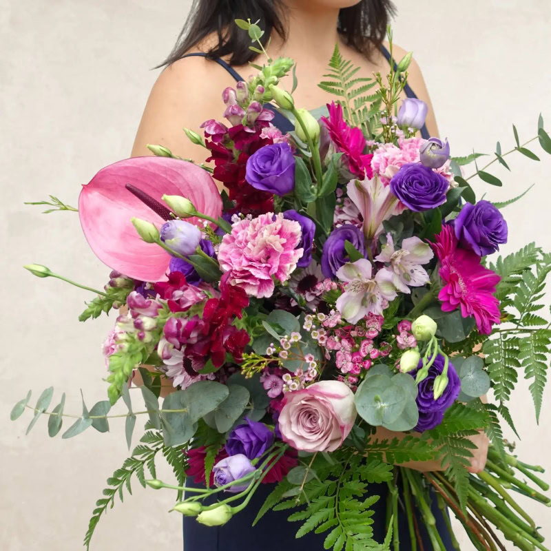 Beautiful mixed flower bouquet with roses, lilies, and greenery from Jubilant Fields Floral Studio.
